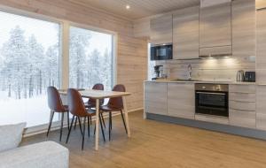 a kitchen with a table and chairs in a room at Villa Lusma in Inari