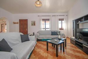 a living room with a couch and a tv at Pearly Sunset in Maryiés