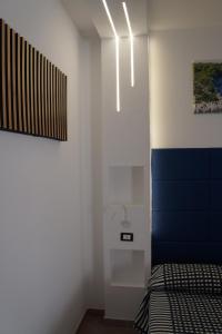 a bedroom with a bed and a blue and white wall at Hotel Parco Carabella in Vieste