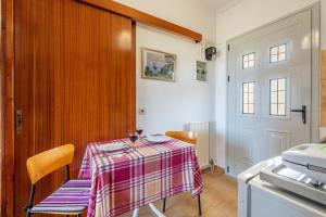 a kitchen with a table with a pink and white table cloth at Lotus Apartment 4 in Almiros Beach +18 photos