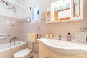 a bathroom with a sink and a toilet at Lotus Apartment 4 in Almiros Beach