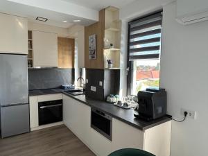 a kitchen with a counter with a tv on it at Coquette Studio Central in Oradea