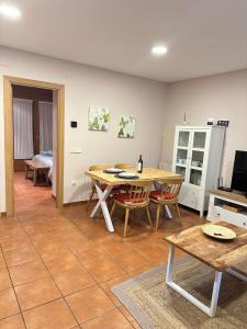 - un salon avec une table et des chaises en bois dans l'établissement Apartamento Rosa Bielsa, à Bielsa