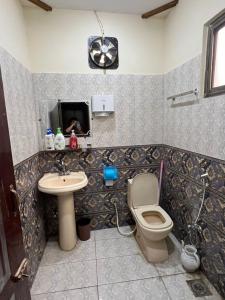 a bathroom with a toilet and a sink at Home in Islamabad in Islamabad