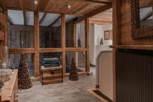 a living room with wooden walls and a large window at Chalet Alice - Les Chalets COVAREL in Val dʼIsère
