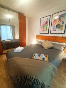 a bedroom with a large bed with a tray on it at Apartamento Terracota Charco del Pino in Tamaide +8 photos