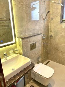 a bathroom with a sink and a toilet and a shower at Aquanique Luxury Living in Dakar