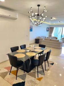 a dining room with a table and chairs and a couch at Aquanique Luxury Living in Dakar