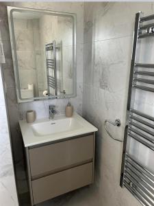 a white bathroom with a sink and a mirror at La Manga Club Resort - 3 bedroom Duplex - La Colina in Atamaría
