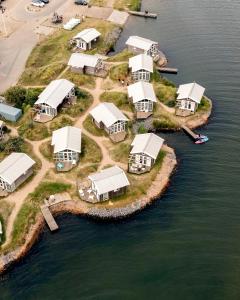 an aerial view of a group of tents in the water at Brouwersdam Stay in Ouddorp
