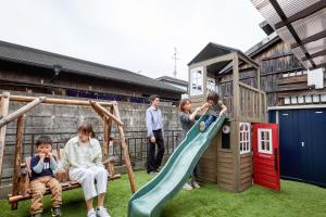 a group of people playing on a playground at Walk to Nara Park-Nara's Timeless Stay in Nara