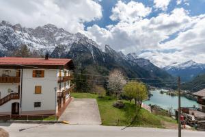 a building with a view of a lake and mountains at Residence Rosental in Alleghe