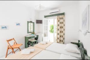 a bedroom with two beds and a desk and a chair at Orion 2 in Naousa