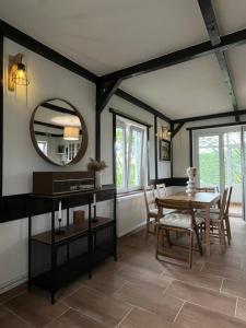 a dining room with a table and a mirror at Villa Buena in Despotovac