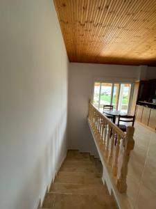 a staircase in a house with a wooden ceiling at Rent Rooms Sakolli in Berat