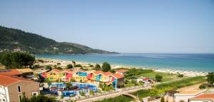 a view of a beach with colorful houses at Alexandra Golden Boutique Hotel-Adults Only in Chrysi Ammoudia