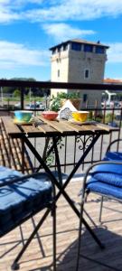 a wooden table with bowls of food on a patio at Dalla Torre al mare in Cervia +20 photos