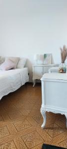a bedroom with a white piano and a bed at Dalla Torre al mare in Cervia