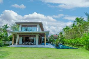a house with a lawn in front of it at 5BedRooms Villas, Experience the luxury vacation The Ocean Estates in Da Nang