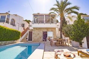 a villa with a swimming pool and a house at Casa Verano - Moraira in Moraira