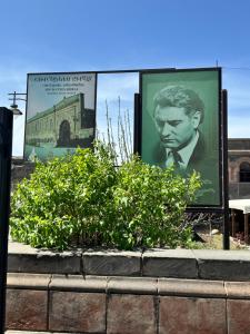 a movie poster of a man in a suit on a billboard at Your Sweet Home Gyumri in Gyumri