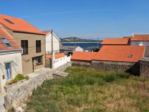 a group of buildings with red roofs and the water at Hideaway Galicia Corrubedo in Corrubedo