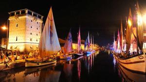 a group of sailboats in the water in front of a castle at Dalla Torre al mare in Cervia