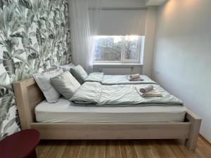 a small bed in a room with a window at Tallinn Panorama Apartment Majaka in Tallinn