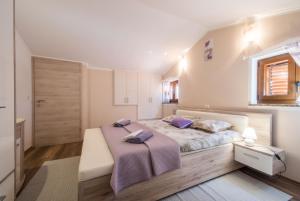 a bedroom with a bed with a pink blanket at Villa Veronika, a cozy and charming Villa for Summer holidays in Lakošelci +28 photos