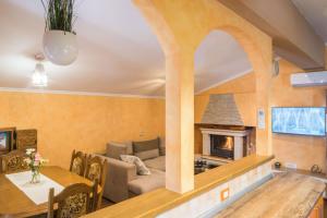 a living room with a couch and a fireplace at Villa Veronika, a cozy and charming Villa for Summer holidays in Lakošelci