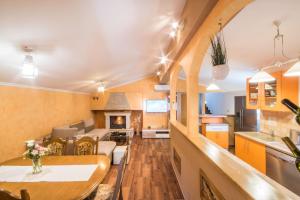 a kitchen and living room with a table and chairs at Villa Veronika, a cozy and charming Villa for Summer holidays in Lakošelci