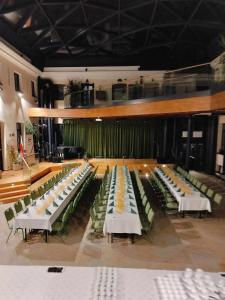 a large room with rows of tables and chairs at Centrum Dialogu Kultur in Węgrów