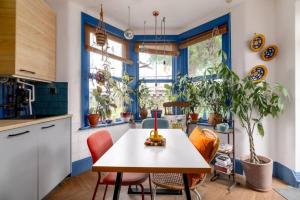 a kitchen with a table and chairs and plants at Boho Hideaway in Lea Bridge in London
