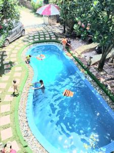 a pool with people playing in the water at Homestay Happy Home Sóc Sơn in Hanoi