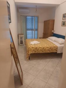 ein Schlafzimmer mit einem Bett in einem Zimmer mit einem Fenster in der Unterkunft Mareluna Casa Del Mare in Ventotene