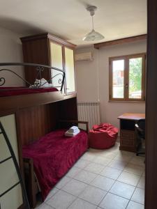 Cette petite chambre comprend un lit et un bureau. dans l'établissement TARANTA HOUSE - Notte della Taranta casa con giardino, à Melpignano