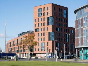 a tall brick building on a city street at Cosy Ensuite Bedrooms at Aspen House in Dublin in Dublin