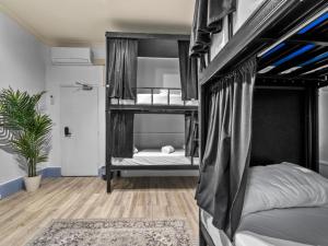 a bedroom with two bunk beds and a rug at Sydney Pod Hotels - Darling Harbour in Sydney