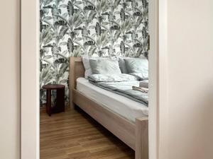 a bedroom with a bed with a floral wallpaper at Tallinn Panorama Apartment Majaka in Tallinn