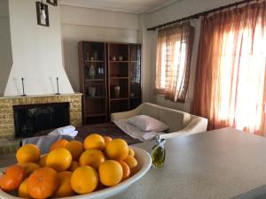 a bowl of oranges on a table in a kitchen at Loulas Beach House Skaloma in Skaloma +27 photos
