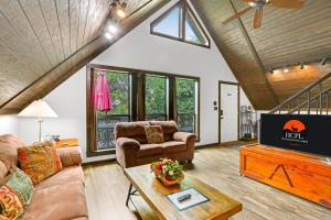 a living room with a couch and a tv at Clutter Falls Retreat - Guest House in New Braunfels