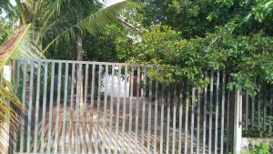 un cancello di metallo con degli alberi dietro. di Oasis Villa a Negombo