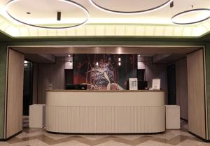 a lobby of a hotel with a reception counter at Hotel Kazzhol Almaty in Almaty