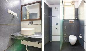 ein Badezimmer mit einem Waschbecken, einem Spiegel und einem WC in der Unterkunft FabExpress The Kings 10 Laxurious in Bangalore