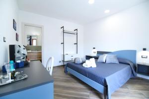 a bedroom with a blue bed and a bathroom at Pina's house in Pianillo
