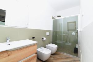 a bathroom with a toilet and a sink and a shower at Pina's house in Pianillo +22 photos