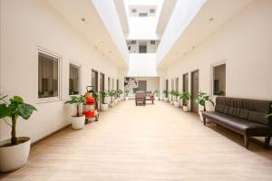 an empty hallway with potted plants in a building at FabHotel Vivek in Muthiganj