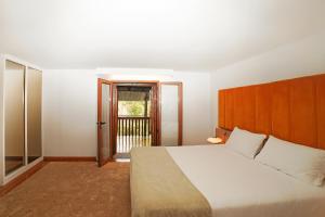 a bedroom with a large white bed and a window at Casa do Solar by Quantique in Proselo +38 photos