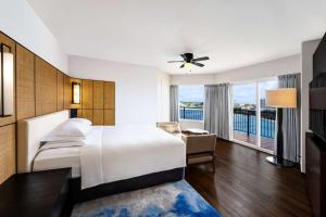 a hotel room with a large bed and a balcony at Hilton Guam Resort & Spa in Tumon