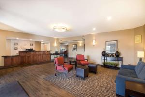 a living room with a couch and a table and chairs at Comfort Inn Fort Morgan in Fort Morgan